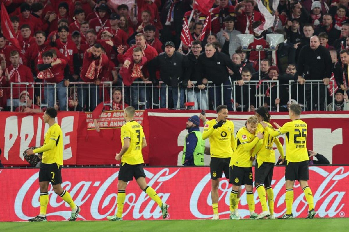 Dortmund's English midfielder #07 Jobe Bellingham (L) celebrates scoring with his teammates before the goal was disallowed for offside by VAR during the German first division Bundesliga football match between FC Bayern Munich and BVB Borussia Dortmund in Munich, southern Germany, on October 31, 2026.  Alexandra BEIER / AFP