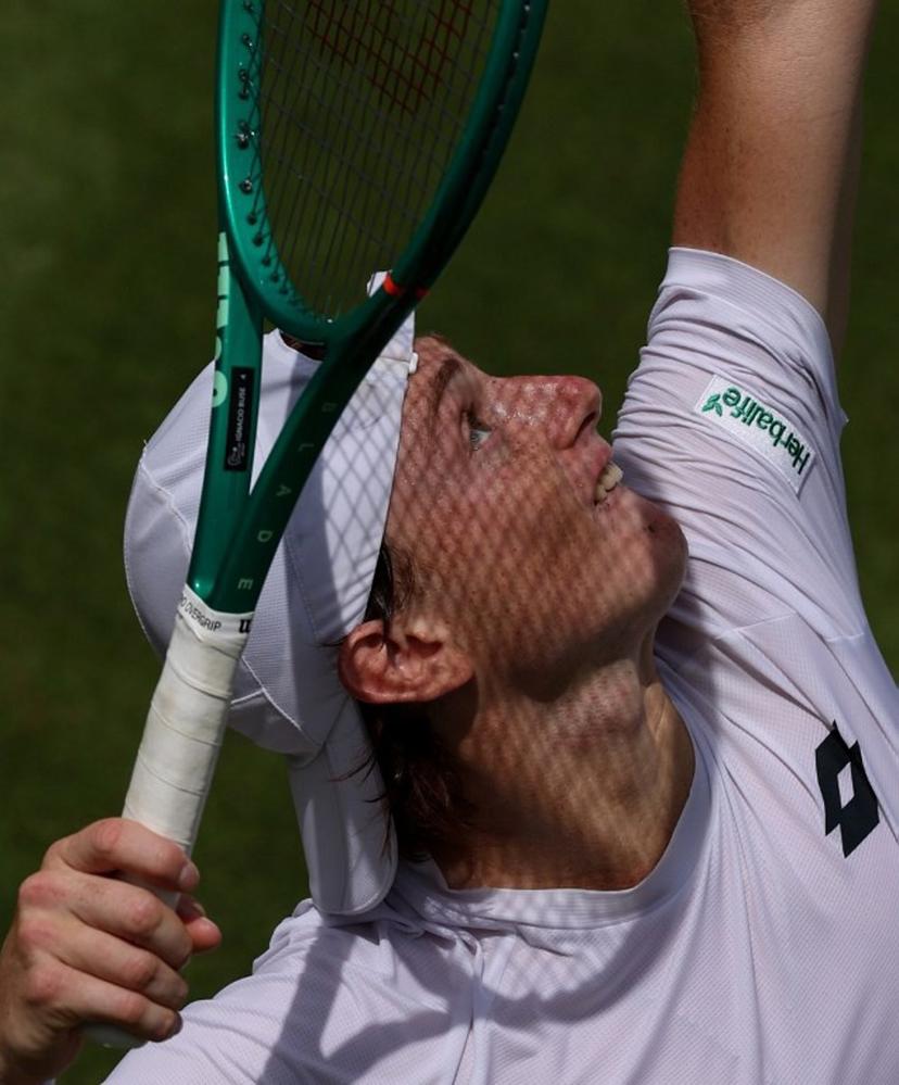Peru's Ignacio Buse serves to US player Jenson Brooksby during their men's singles second round tennis match on the third day of the 2026 Wimbledon Championships at The All England Lawn Tennis and Croquet Club in Wimbledon, southwest London, on July 1, 2026.  Adrian Dennis / AFP