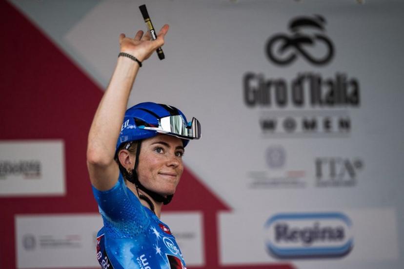 FDJ Suez's Dutch cyclist Demi Vollering, wearing the best climber's blue jersey (Maglia Azzurra), waves during the pre-stage presentation ahead of the 9th stage of the Giro d'Italia Women 2026 between Saluzzo and Saluzzo in Saluzzo on June 7, 2026.  MARCO BERTORELLO / AFP