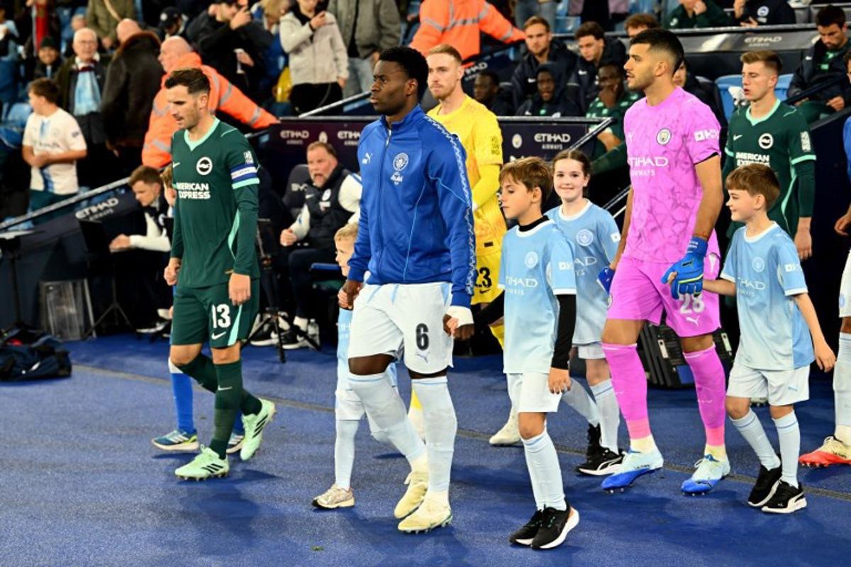 Manchester City's English defender #06 Marc Guehi leads his teammates out before the English League Cup fourth round football match between Manchester City and Brighton and Hove Albion at the Etihad stadium in Manchester, north-west England on October 28, 2026.  PETER POWELL / AFP