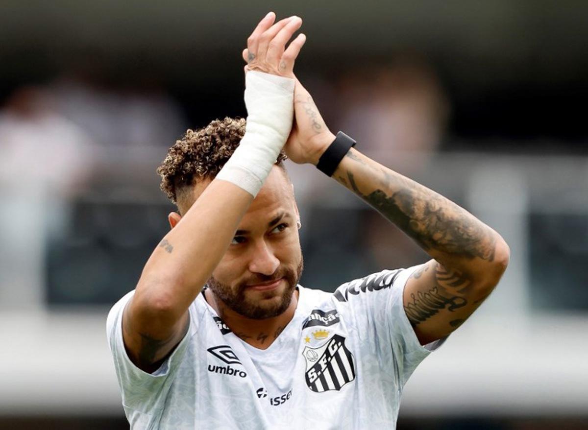 (FILES) Santos' froward #10 Neymar greets fans during a tribute for scoring 150 goals for the club, before the Brasileirao Serie A football match between Santos and Cruzeiro at the Urbano Caldeira Stadium in Santos, Sao Paulo state, Brazil on December 7, 2025. Crucial goals in the final stretch to save Santos from relegation in Brazilian football, injuries, harsh criticism and a future full of doubts: Neymar had a crazy 2025. Miguel Schincariol / AFP
