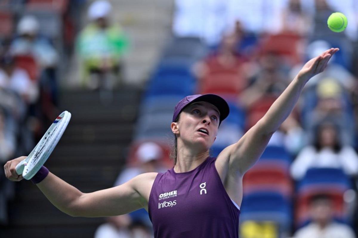 Poland's Iga Swiatek serves to Poland's Magdalena Frech during their women's singles match at the Wuhan Open tennis tournament in Wuhan, China's Hubei province on October 14, 2026.   WANG Zhao / AFP