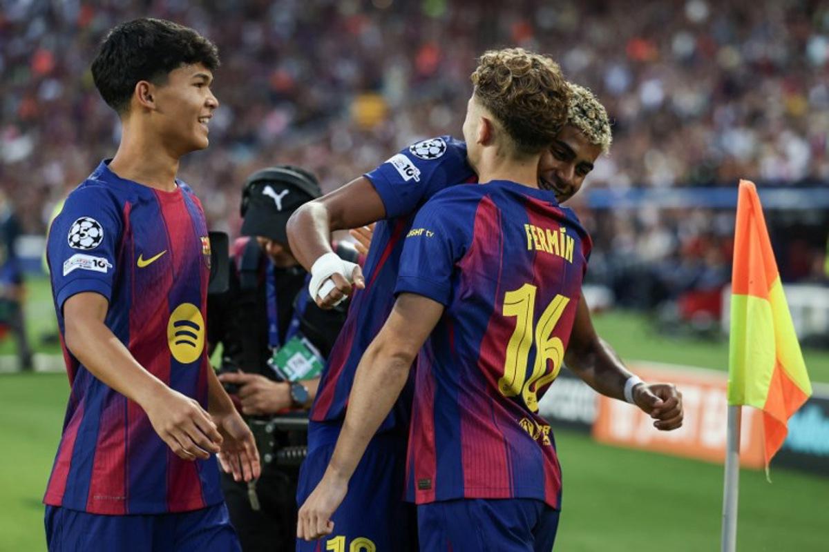 Barcelona's Spanish midfielder #16 Fermin Lopez (R) celebrates scoring their first goal with Barcelona's Spanish forward #10 Lamine Yamal and Barcelona's Spanish midfielder #27 Pedro Fernandez "Dro" (L) during the UEFA Champions League league phase match-day 3 football match between FC Barcelona and Olympiakos FC at Estadi Olimpic Lluis Companys in Barcelona on October 21, 2025.  Josep LAGO / AFP