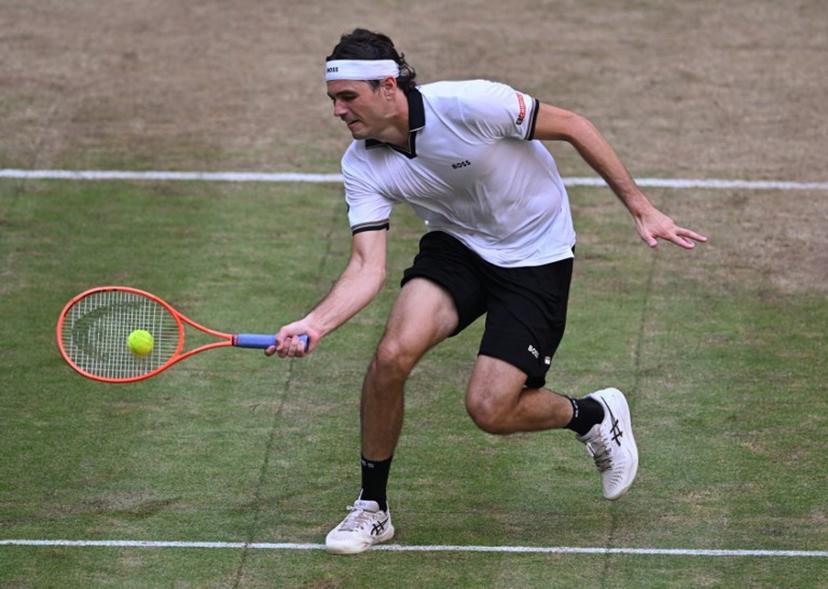 Taylor Fritz of the US returns the ball to Germany's Alexander Zverev during their men's singles semi-final match of the Halle Open ATP tennis tournament in Halle, western Germany, on June 20, 2026.  CARMEN JASPERSEN / AFP