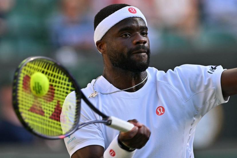US player Frances Tiafoe returns to Kazakhstan's Alexander Bublik during their men's singles third round tennis match on the sixth day of the 2026 Wimbledon Championships at The All England Lawn Tennis and Croquet Club in Wimbledon, southwest London, on July 4, 2026.  Glyn KIRK / AFP