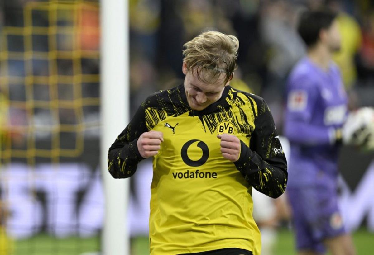 Dortmund's German midfielder #10 Julian Brandt celebrates after scoring the 1-0 goal during the German first division Bundesliga football match between BVB Borussia Dortmund and FC St Pauli in Dortmund, western Germany, on January 17, 2026.  INA FASSBENDER / AFP