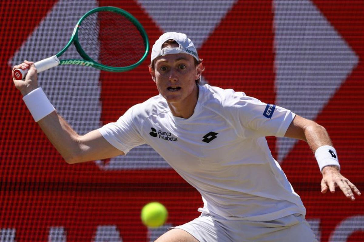 Peru's Ignacio Buse hits a return against Brandon Nakashima of the US during their men's singles round of 16 tennis match on day three of the ATP HSBC Championships at Queen's Club in west London on June 17, 2026.  Adrian Dennis / AFP