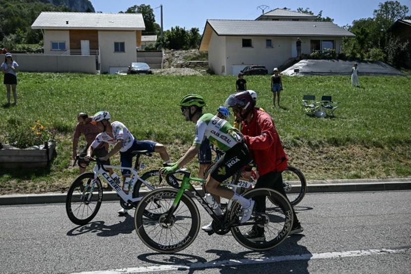 TotalEnergies team's French rider Alexandre Delettre and Caja Rural - Seguros RGA team's Spanish rider Jose Felix Parra receive assistance after a crash during the 17th stage of the 113th edition of the Tour de France cycling race, 174,7 km between Chambéry and Voiron in the French Alps, on July 22, 2026.  Loic VENANCE / AFP