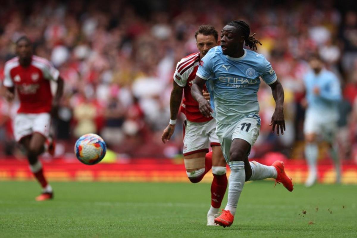 Manchester City's Belgian midfielder #11 Jeremy Doku runs with the ball during the English FA Community Shield football match between Arsenal and Manchester City at The Principality Stadium, in Cardiff, south Wales on August 16, 2026.  Adrian Dennis / AFP
