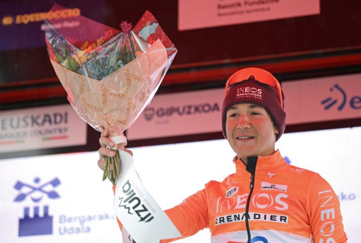 Stage winner team Ineos' US rider AJ August celebrates on the podium after the sixth and last stage of the Basque Country's Itzulia cycling tour, a 135.4 km race between Goizper-Antzuola and Bergara, on April 11, 2026.   ANDER GILLENEA / AFP