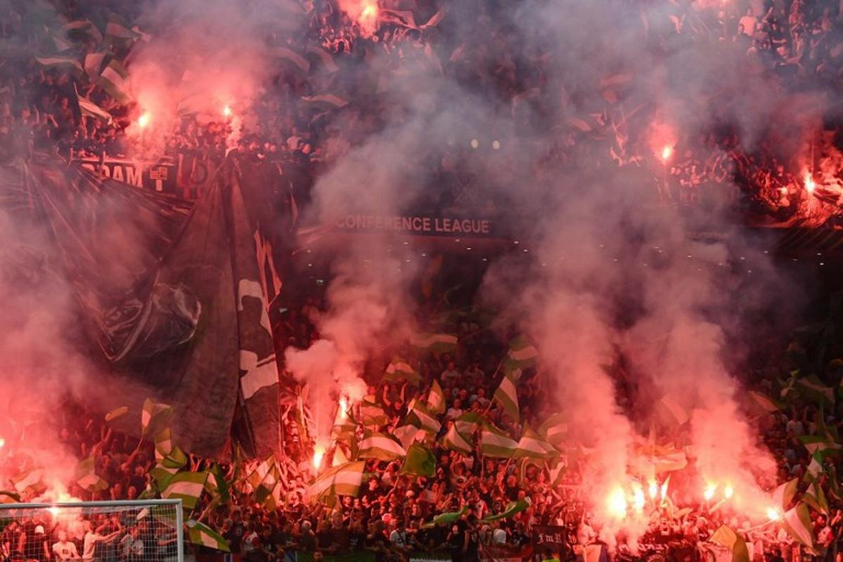 Feyenoord fans light flares during the UEFA Europa Conference League final football match between AS Roma and Feyenoord at the Air Albania Stadium in Tirana on May 25, 2022.  OZAN KOSE / AFP