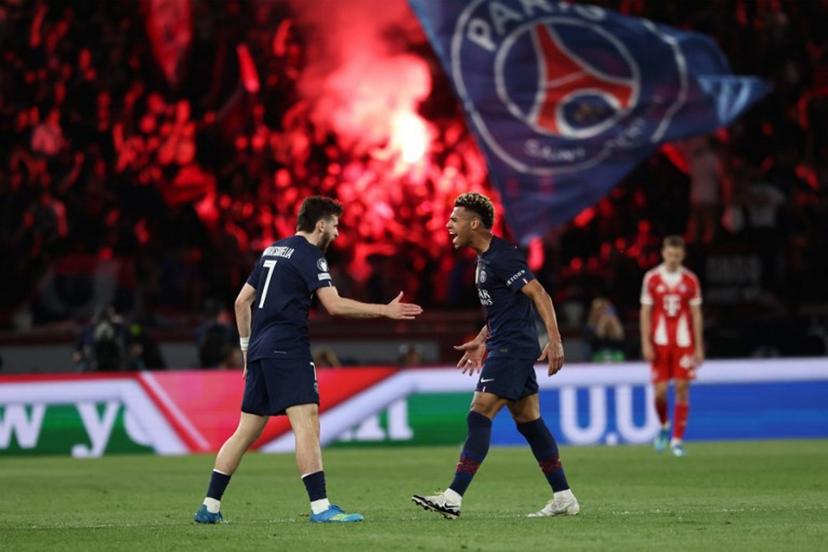 Paris Saint-Germain's Georgian forward #07 Khvicha Kvaratskhelia (L) celebrates with Paris Saint-Germain's French midfielder #14 Desire Doue after scoring his team first goal during the UEFA Champions League semi-final first leg football match between Paris Saint-Germain (PSG) and Bayern Munich at the Parc des Princes in Paris on April 28, 2026.  Anne-Christine POUJOULAT / AFP