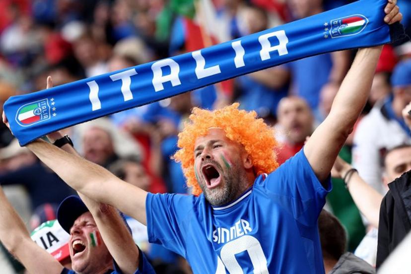 A fan of Italy cheers holding an Italian scarf prior the UEFA Euro 2024 Group B football match between Italy and Albania at the BVB Stadion in Dortmund, western Germany, on June 15, 2024.  FRANCK FIFE / AFP