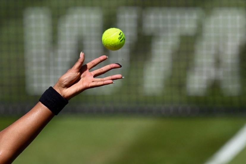 The hand of Japan's Naomi Osaka is pictured as she serves the ball while the WTA logo is seen in the background, during the women's singles quarter-final match of the WTA 500 Bad Homburg Open tennis tournament in Bad Homburg, western Germany on June 25, 2026.  Kirill KUDRYAVTSEV / AFP
