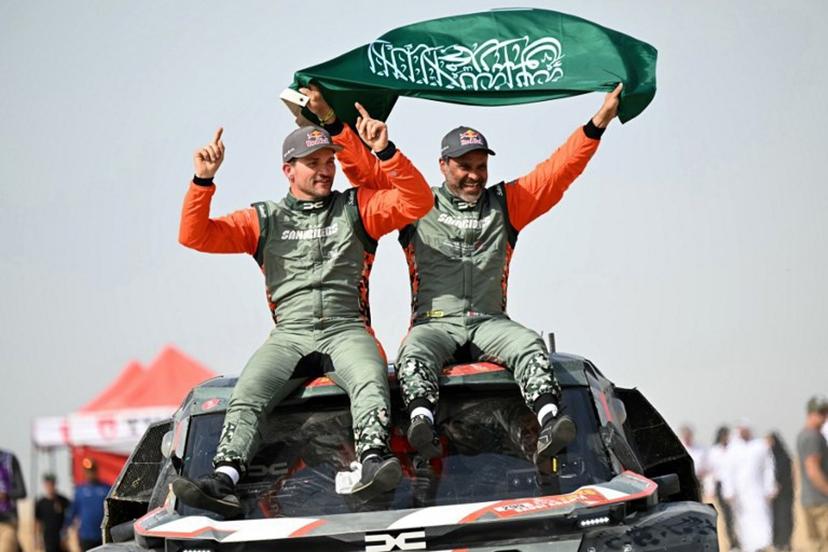 The Dacia Sandriders' Qatari driver Nasser al-Attiyah (R) and Belgian copilot Fabian Lurquin celebrate after winning the 48th edition of the Dakar Rally 2026 in Yanbu, Saudi Arabia, on January 17, 2026. Qatar's Nasser Al-Attiyah secured his sixth Dakar Rally car title in Saudi Arabia. Giuseppe CACACE / AFP