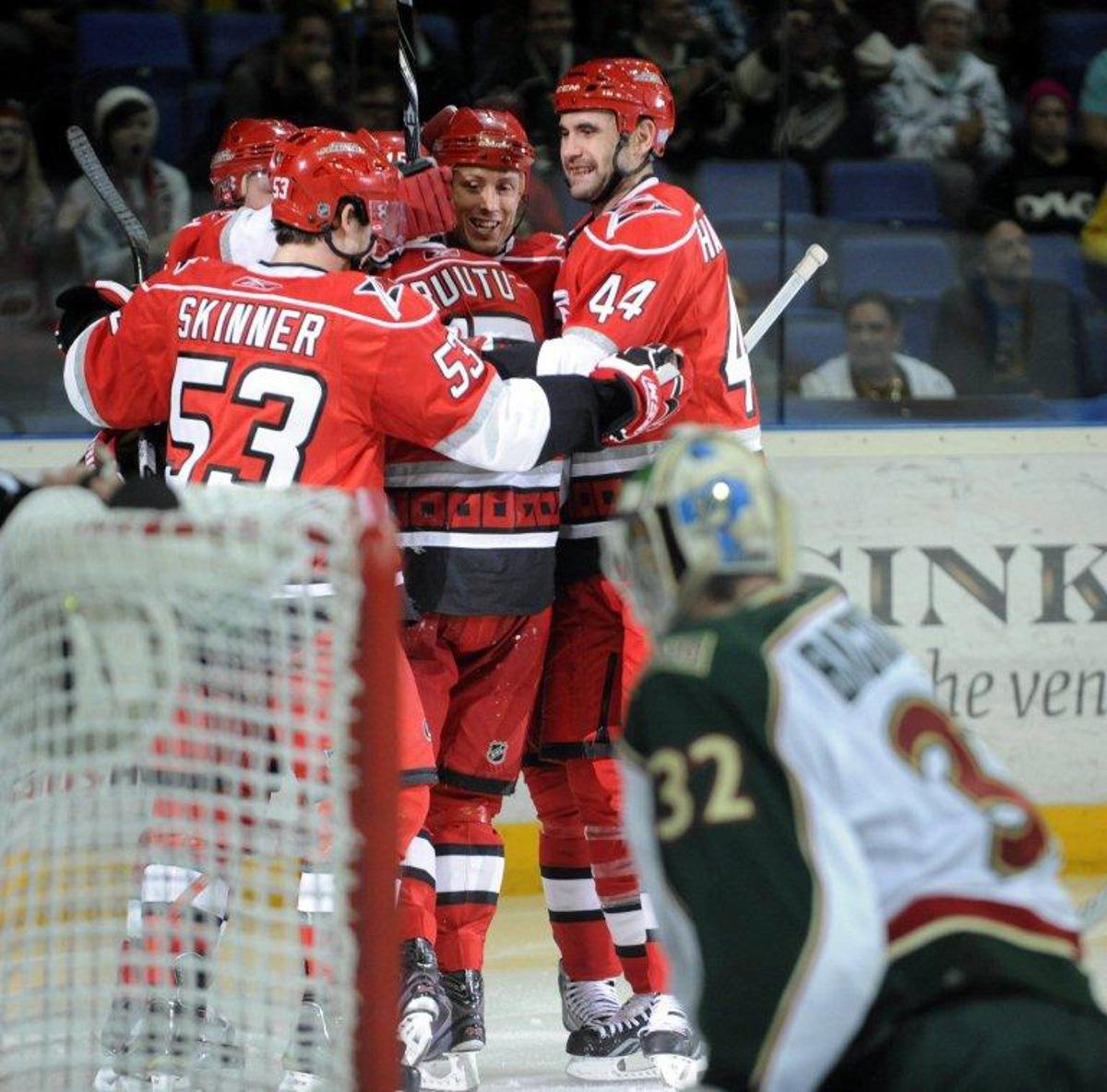 Hurricanes' Jeff Skinner (L), Jay Harrison (R) and Jussi Jokinen (L) celebrate Tuomo Ruutu's (C) game-tying 1-1 goal  during the ice hockey NHL regular season game Carolina Hurricanes vs Minnesota Wild  in Helsinki on October 8, 2010. AFP PHOTO LEHTIKUVA / Heikki Saukkomaa *** FINLAND OUT ***  LEHTIKUVA / AFP FINLAND OUT.

