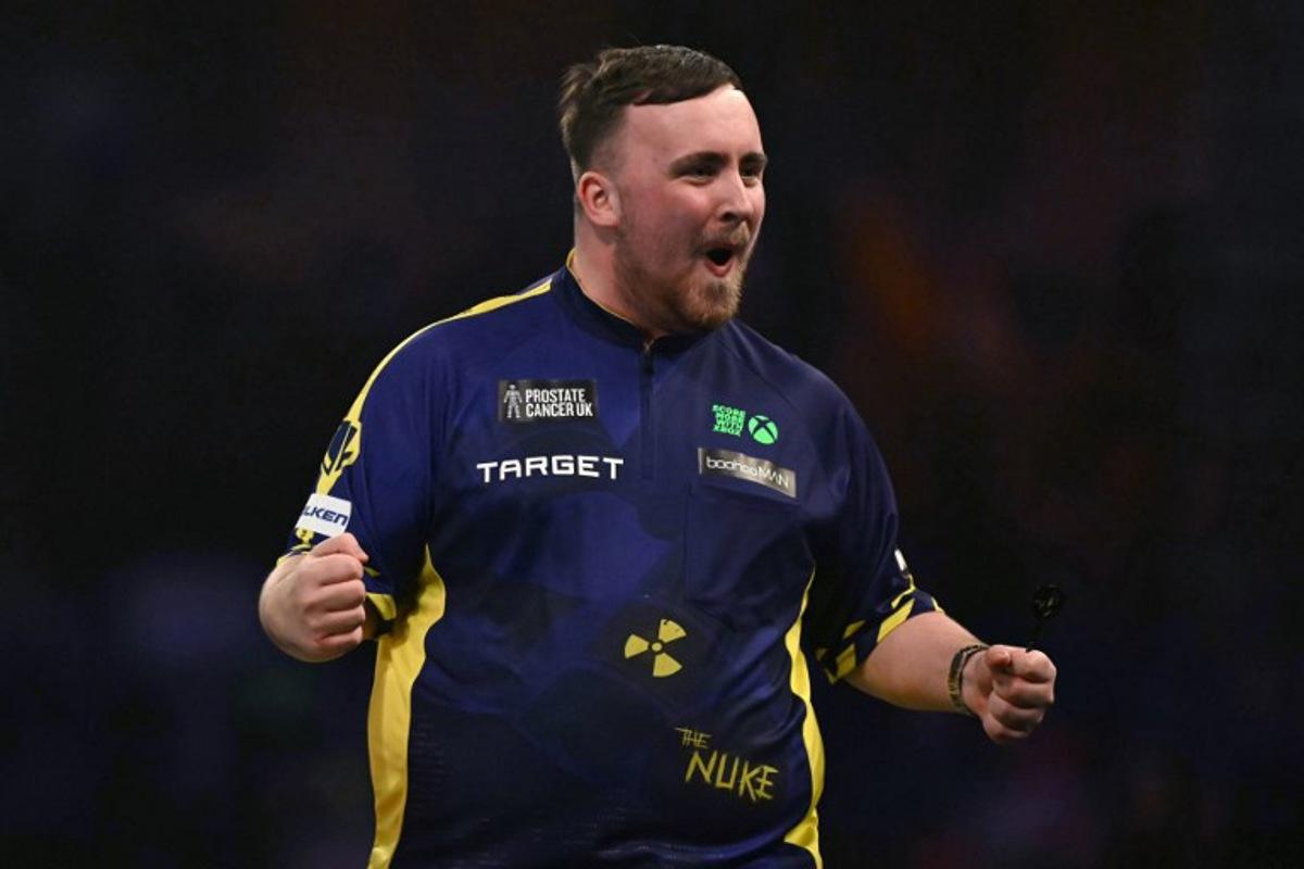 England's Luke Littler celebrates winning the fourth set against Netherlands' Michael van Gerwen during the PDC World Darts Championship final, at Alexandra Palace in London on January 3, 2025.  Ben STANSALL / AFP