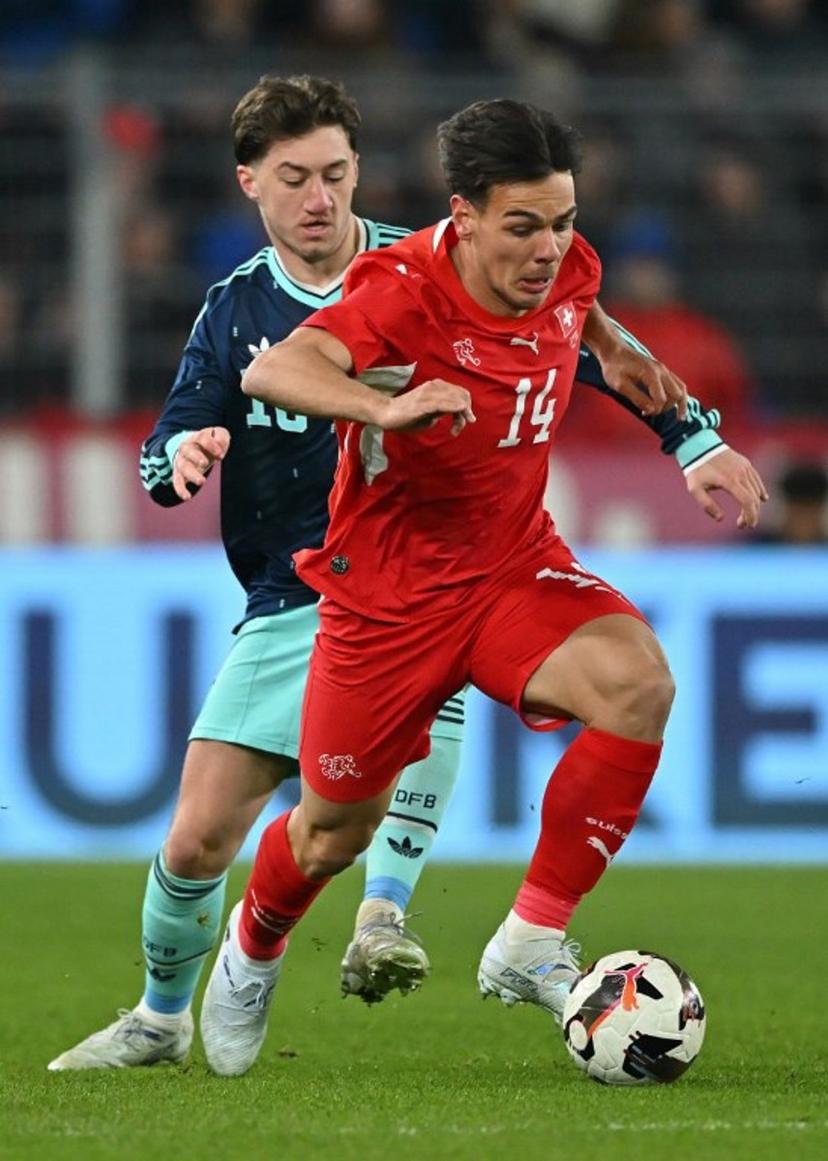 Germany's midfielder Angelo Stiller fights for the ball with Switzerland's midfielder #14 Ardon Jashari during the international friendly football match between Switzerland and Germany at St. Jakob-Park in Basel, Switzerland on March 27, 2026.  Fabrice COFFRINI / AFP