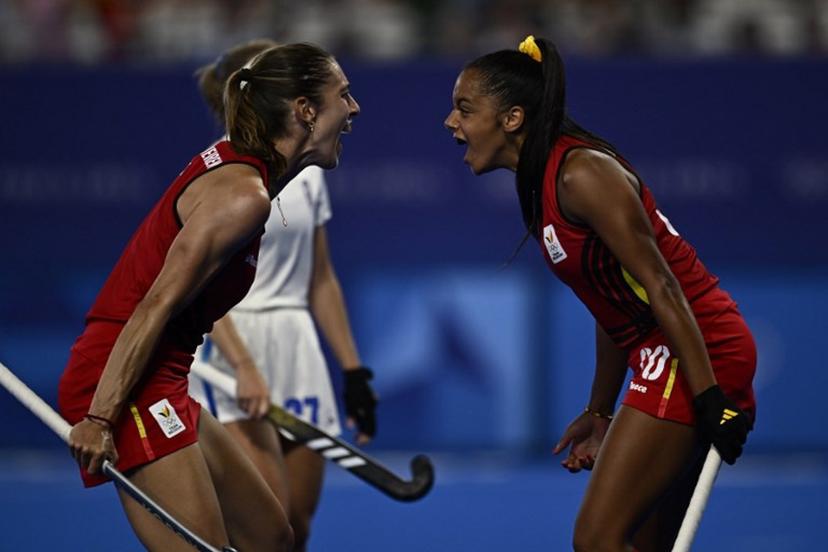 Belgium's forward #30 Ambre Ballenghien celebrates with Belgium's midfielder #07 Judith Vandermeiren after scoring her team's fifth goal in the women's pool A field hockey match between France and Belgium during the Paris 2024 Olympic Games at the Yves-du-Manoir Stadium in Colombes on July 29, 2024.  JULIEN DE ROSA / AFP