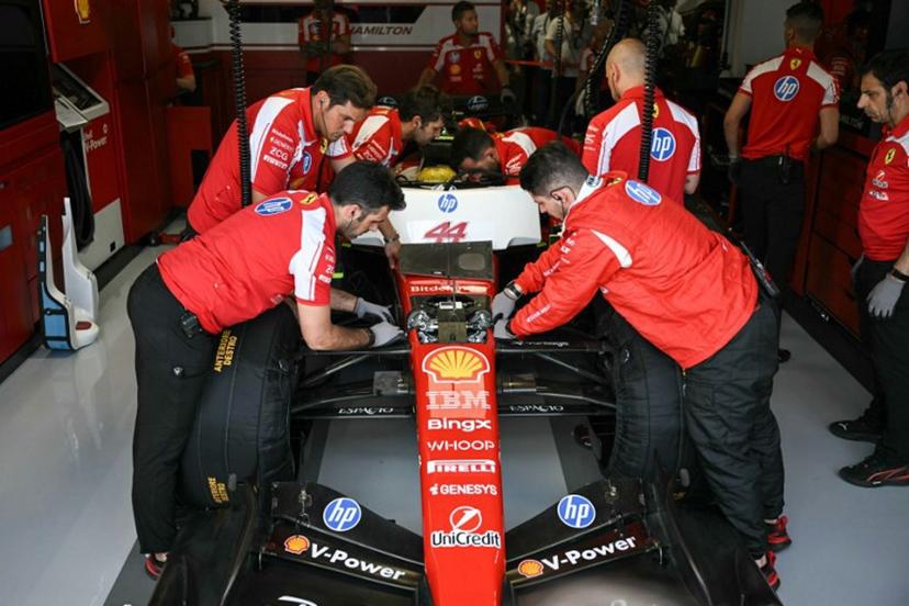 Ferrari technicians work on the car of Ferrari's British driver Lewis Hamilton in the garage during a practice session for the 2026 Miami Formula One Grand Prix at Miami International Autodrome in Miami Gardens, Florida, on May 1, 2026.   CHANDAN KHANNA / AFP