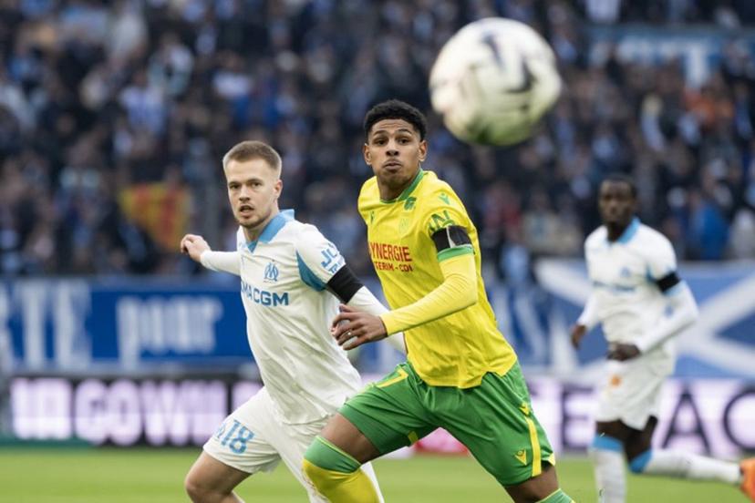 Nantes' French midfielder #17 Dehmaine Tabibou (R) and Marseille's Belgian midfielder #18 Arthur Vermeeren run for the ball during the French L1 football match between Olympique de Marseille (OM) and FC Nantes at the Stade Velodrome in Marseille, southern France on January 4, 2026.  MIGUEL MEDINA / AFP