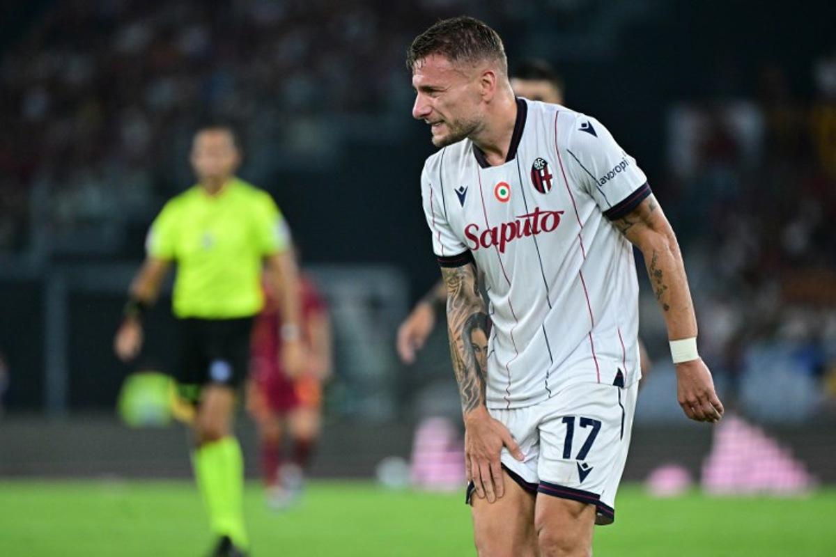 Bologna's Italian forward #17 Ciro Immobile reacts after an injury during the Italian Serie A football match between AS Roma and Bologna at the Olympic Stadium in Rome on August 23, 2025.  Tiziana FABI / AFP