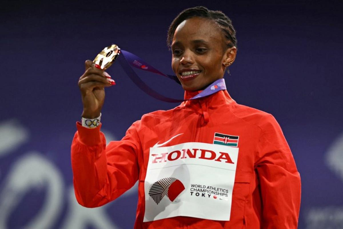 Gold medallist Kenya's athlete Beatrice Chebet celebrates on the podium for the women's 5000m final during the World Athletics Championships in Tokyo on September 21, 2025.  Philip FONG / AFP