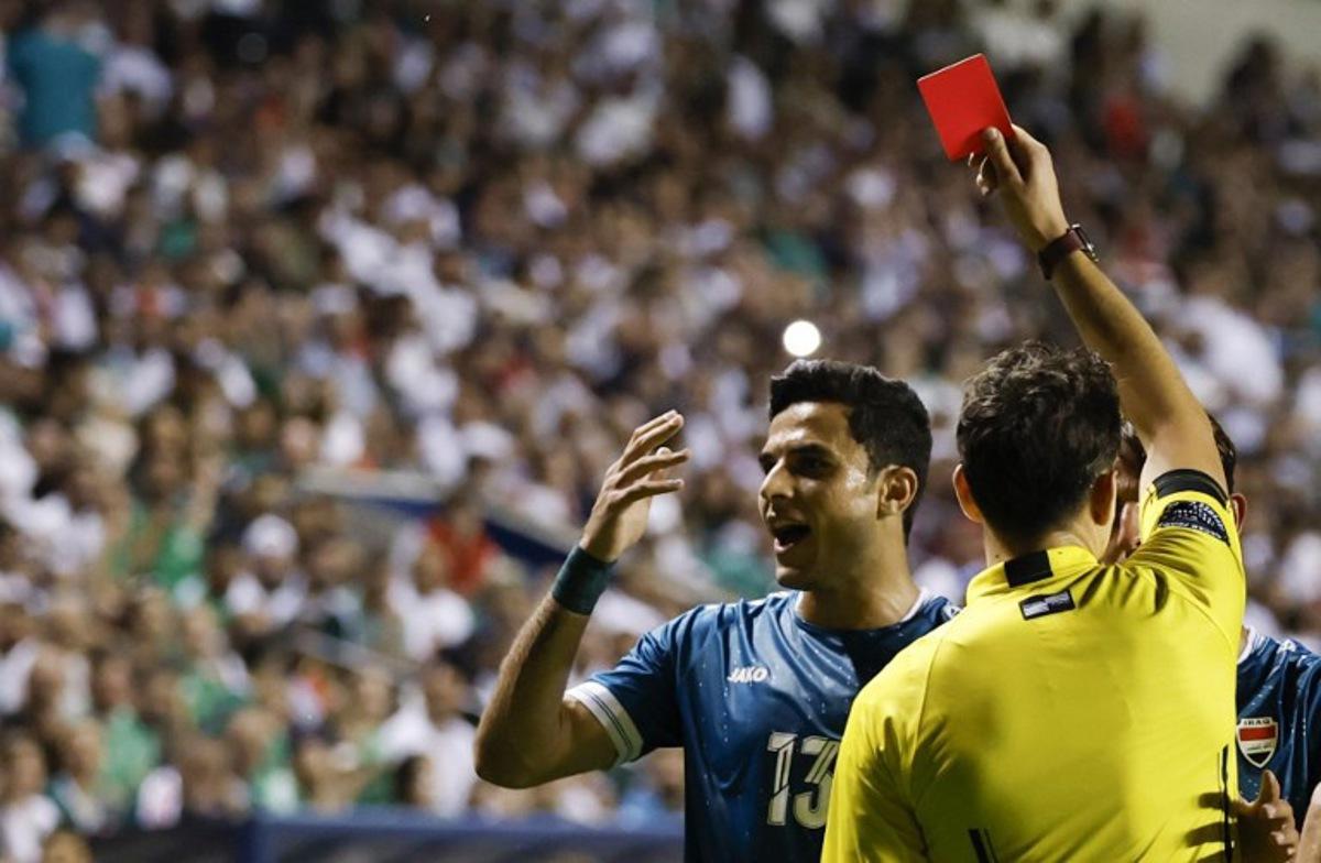 Referee shows a red card to Iraq's forward #13 Ali Yousif during the international friendly football match between Iraq and Venezuela at SeatGeek Stadium in Bridgeview, Illinois on June 9, 2026.  KAMIL KRZACZYNSKI / AFP