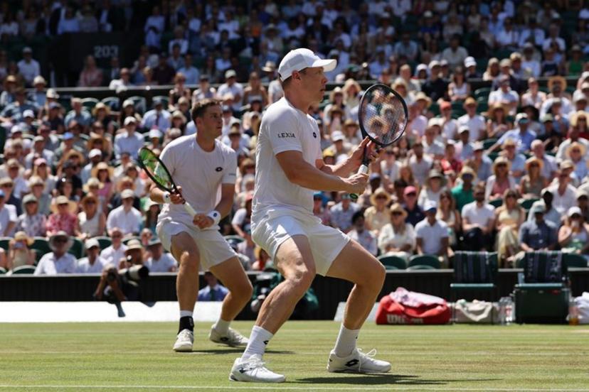Britain's Henry Patten and Finland's Harri Heliovaara wait for a return from El Salvador's Marcelo Arevalo and Croatia's Mate Pavic during their men's doubles final tennis match on the thirteenth day of the 2026 Wimbledon Championships at The All England Lawn Tennis and Croquet Club in Wimbledon, southwest London, on July 11, 2026.  Adrian Dennis / AFP