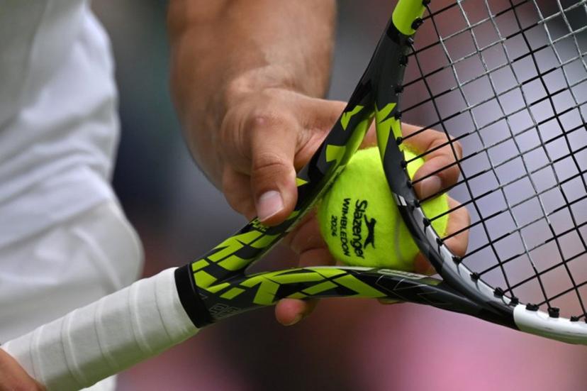Spain's Carlos Alcaraz prepares to serve a ball against Estonia's Mark Lajal during their men's singles tennis match on the first day of the 2024 Wimbledon Championships at The All England Lawn Tennis and Croquet Club in Wimbledon, southwest London, on July 1, 2024.  Glyn KIRK / AFP
