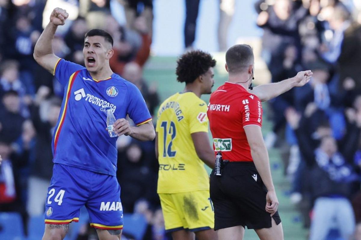 Getafe's Argentine defender #24 Zaid Romero Player celebrates as referee awards penalty against Villarrea during the Spanish league football match between Getafe CF and Villarreal CF at Coliseum Alfonso Perez Stadium in Getafe on February 14, 2026.  Oscar DEL POZO / AFP