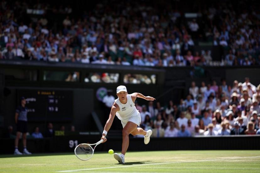Poland's Iga Swiatek returns to Philippines' Alexandra Eala during their women's singles third round tennis match on the sixth day of the 2026 Wimbledon Championships at The All England Lawn Tennis and Croquet Club in Wimbledon, southwest London, on July 4, 2026.  HENRY NICHOLLS / AFP