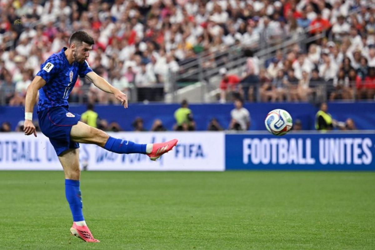 Croatia's midfielder #17 Petar Sucic kicks the ball during the 2026 World Cup Group L football match between England and Croatia at the Dallas Stadium in Arlington on June 17, 2026.   Paul ELLIS / AFP