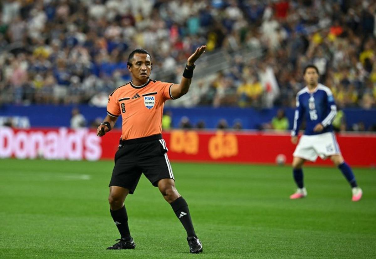 Salvadoran referee Ivan Barton gestures during the 2026 World Cup Group F football match between Japan and Sweden at the Dallas Stadium in Arlington on June 25, 2026.   Paul ELLIS / AFP