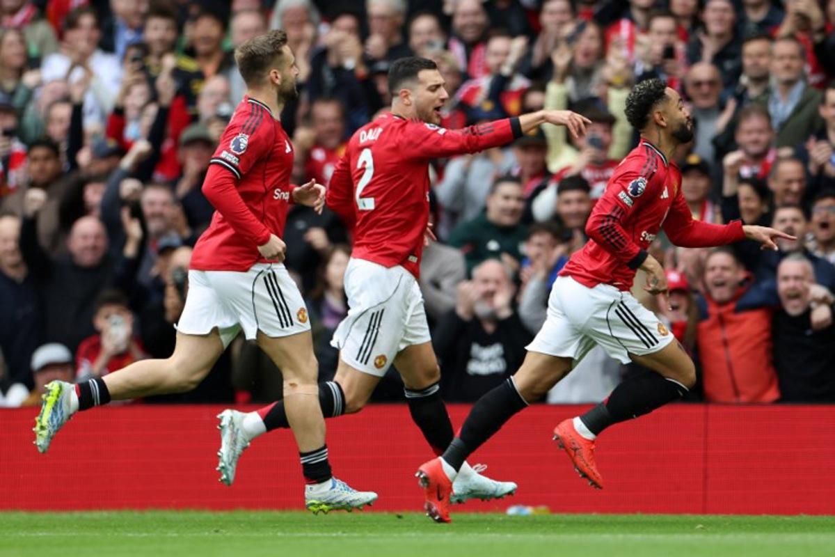 Manchester United's Brazilian striker #10 Matheus Cunha (R) celebrates scoring the team's first goal during the English Premier League football match between Manchester United and Liverpool at Old Trafford in Manchester, north west England, on May 3, 2026.  Darren Staples / AFP