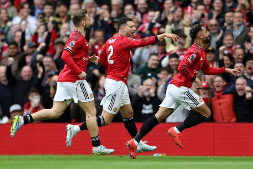 Manchester United's Brazilian striker #10 Matheus Cunha (R) celebrates scoring the team's first goal during the English Premier League football match between Manchester United and Liverpool at Old Trafford in Manchester, north west England, on May 3, 2026.  Darren Staples / AFP