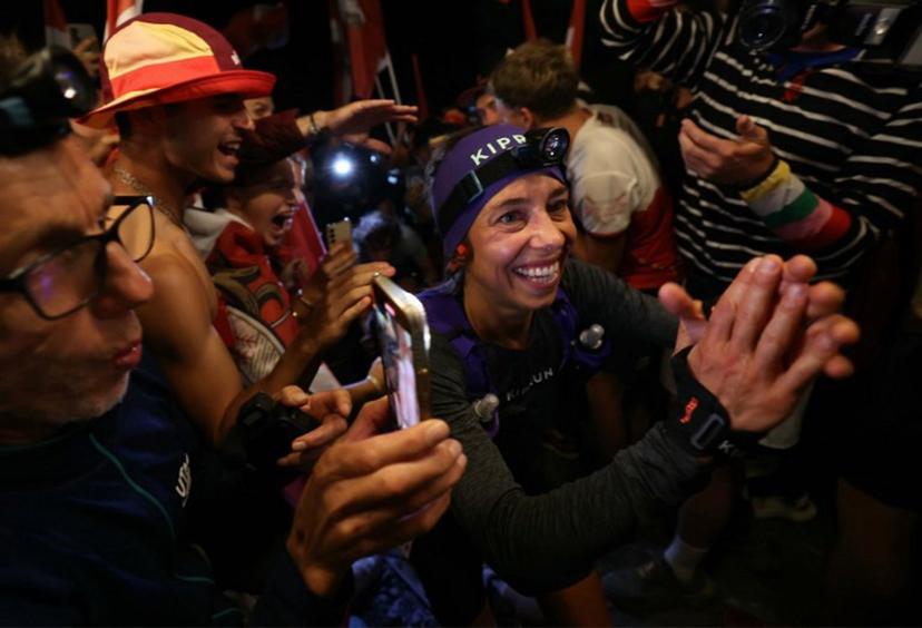 French runner Blandine L'Hirondelle is welcomed by supporters as he climbs the Notre Dame de la Gorge during the Ultra-Trail du Mont Blanc (UTMB) in Les Contamines-Montjoie on August 30, 2024.  EMMANUEL DUNAND / AFP