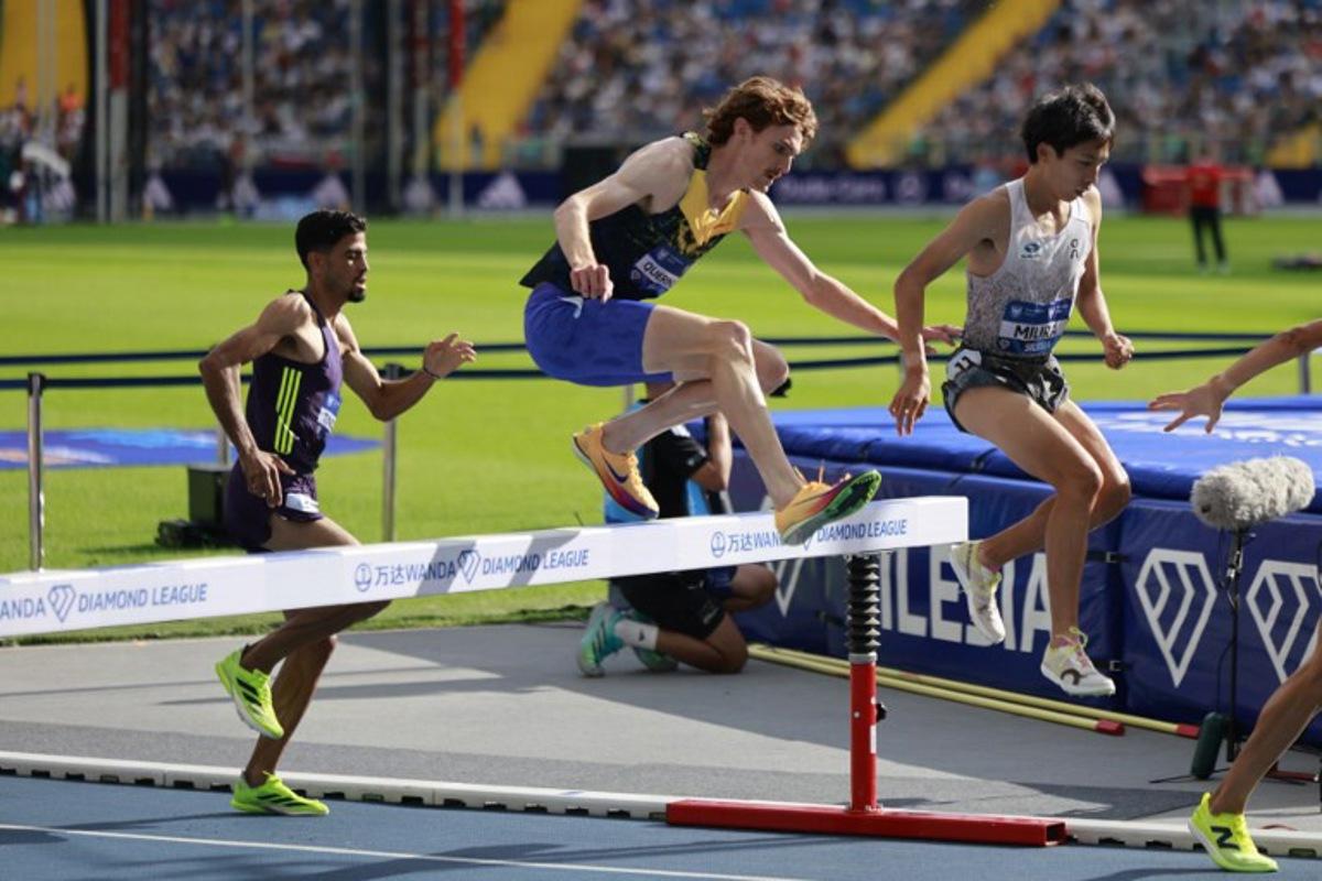 Japan's Ryuji Miura (R), Luxembourg's Ruben Querinjean (C) and Marocco's Mohamed Tindouft (L) compete in the 3000 m Steeple Chase competition of the Silesia Diamond League athletics meeting in Katowice, Poland, on August 23, 2026.  Wojtek RADWANSKI / AFP