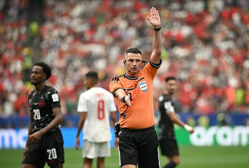 English referee Michael Oliver gestures during the 2026 World Cup round of 16 football match between Canada and Morocco at the Houston Stadium in Houston on July 4, 2026.   Paul ELLIS / AFP