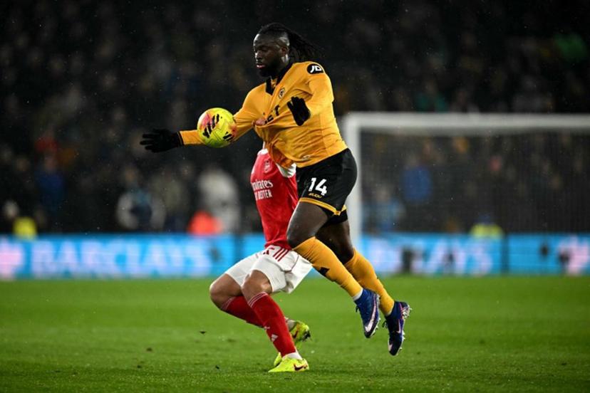 Arsenal's French defender #02 William Saliba pulls the shirt of Wolverhampton Wanderers' Nigerian striker #14 Tolu Arokodare during the English Premier League football match between Wolverhampton Wanderers and Arsenal at the Molineux stadium in Wolverhampton, central England on February 18, 2026.  Paul ELLIS / AFP