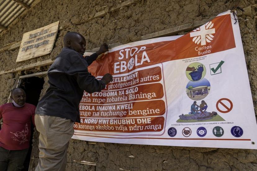 A man hangs an Ebola awareness banner in the Kigonze camp in Bunia, in the eastern Democratic Republic of the Congo, on May 28, 2026. An Ebola hemorrhagic fever outbreak is spreading rapidly in the east of the Democratic Republic of Congo, one of the poorest countries in the world. More than 1,000 suspected cases - including 223 deaths - have so far been recorded in the DRC by the World Health Organization (WHO). Nearly one million people have been displaced by conflict in Ituri province, the epicenter of the outbreak and one of the most troubled areas of the DRC, where armed groups, rebels linked to the Islamic State, and community militias regularly carry out massacres. Glody MURHABAZI / AFP