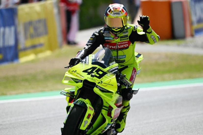 Team Pertamina Enduro VR46 Racing Team's Fabio Di Giannantonio celebrates his thirs place after the Sprint Race at the Catalunya Moto GP Grand Prix at the Catalunya racetrack in Montmelo, near Barcelona, on May 16, 2026.  Jose Jordan / AFP