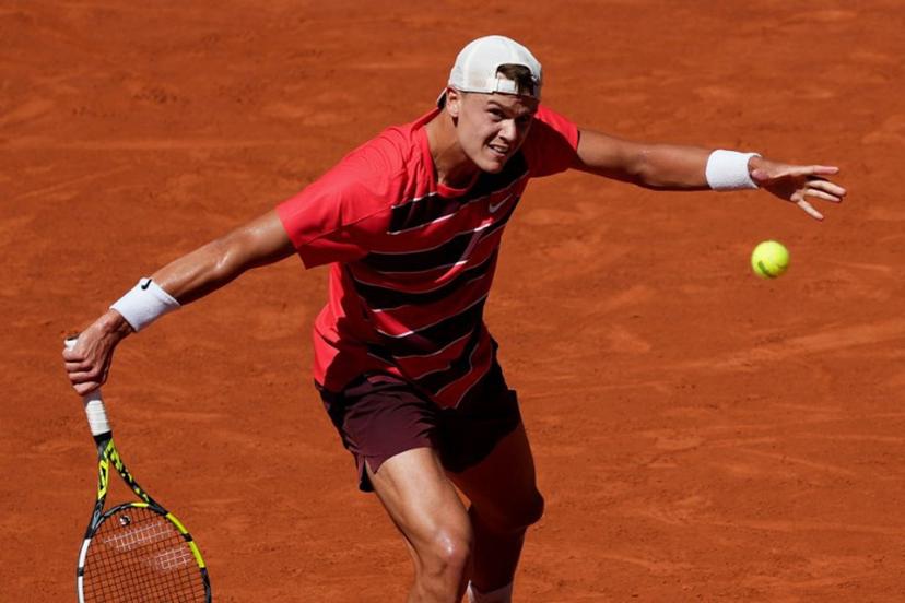 Denmark's Holger Rune plays a backhand return to France's Quentin Halys during their men's singles match on day 6 of the French Open tennis tournament on Court Philippe-Chatrier at the Roland-Garros Complex in Paris on May 30, 2025.  Dimitar DILKOFF / AFP
