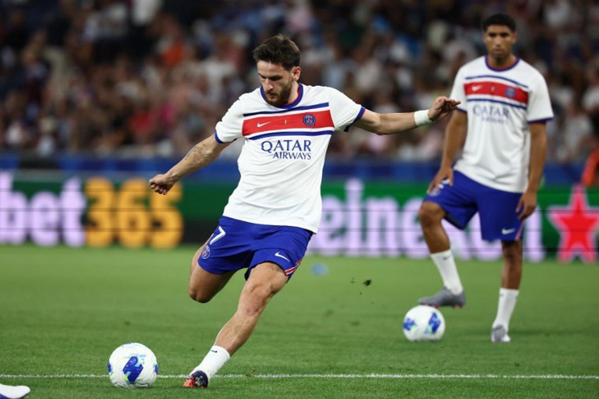 Paris Saint-Germain's Georgian forward #07 Khvicha Kvaratskhelia shoots during the warm up prior to the UEFA Supercup football match between Champions League winners Paris Saint Germain (PSG) and Europa League winners Aston Villa in Salzburg, Austria on August 12, 2026.  FRANCK FIFE / AFP