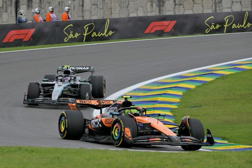 McLaren's British driver Lando Norris (R) races ahead of Mercedes' Italian driver Kimi Antonelli (L) during the sprint of the Sao Paulo Formula One Grand Prix at the Jose Carlos Pace racetrack, aka Interlagos, in Sao Paulo, Brazil on November 8, 2025.  Nelson ALMEIDA / AFP
