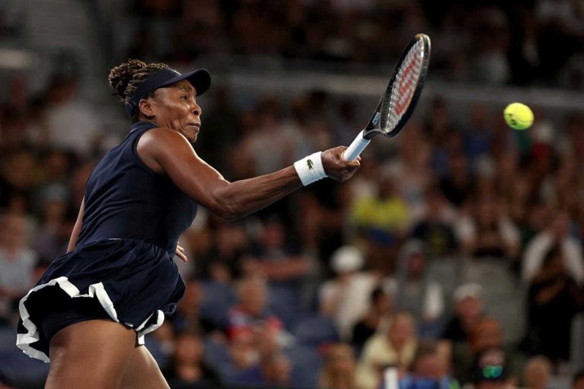 USA's Venus Williams hits a return to Serbia's Olga Danilovic during their women's singles match on day one of the Australian Open tennis tournament in Melbourne on January 18, 2026.  Martin KEEP / AFP