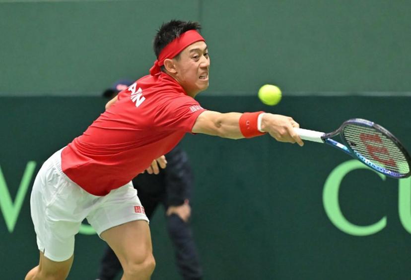 Japan's Kei Nishikori returns a shot against Britain's Jacob Fearnley during their men's singles match of the Davis Cup team tennis qualifiers at Bourbon Beans Dome in Miki, Hyogo Prefecture on January 31, 2025.   STR / JIJI Press / AFP