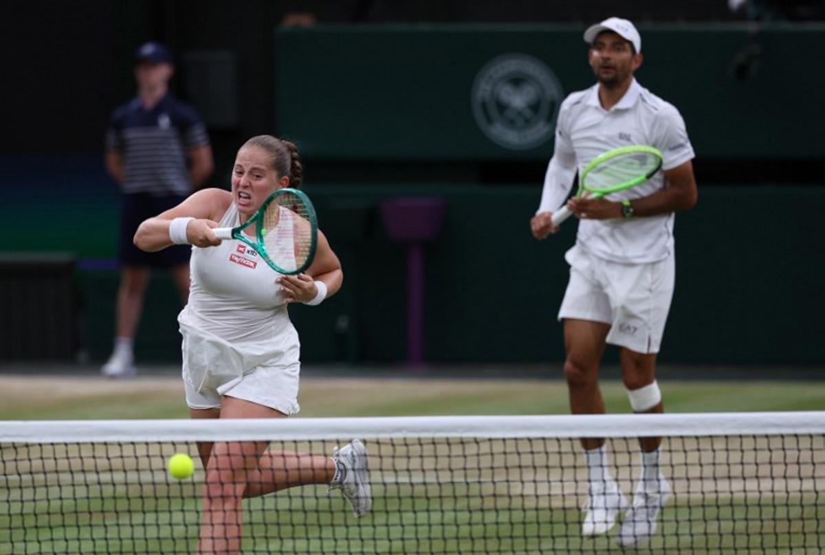 El Salvador's Marcelo Arevalo (R) and Latvia's Jelena Ostapenko play against Australia's players Marc Polmans and Storm Hunter during their mixed's doubles final tennis match on the eleventh day of the 2026 Wimbledon Championships at The All England Lawn Tennis and Croquet Club in Wimbledon, southwest London, on July 9, 2025.  Adrian Dennis / AFP