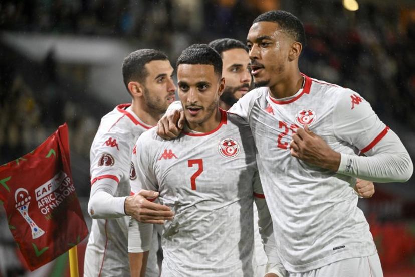 Tunisia's forward #07 Elias Achouri is congratulated by Tunisia's midfielder #17 Ellyes Skhiri, Tunisia's defender #06 Dylan Bronn and Tunisia's defender #20 Yan Valery during the Africa Cup of Nations (CAN) Group C football match between Tunisia and Uganda at Rabat Olympic Stadium in Rabat on December 23, 2025.   SEBASTIEN BOZON / AFP