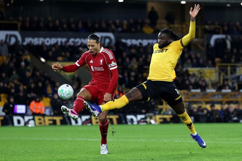 Liverpool's Dutch defender #04 Virgil van Dijk battles for possession with Wolverhampton Wanderers' Nigerian striker #14 Tolu Arokodare during the English Premier League football match between Wolverhampton Wanderers and Liverpool at the Molineux stadium in Wolverhampton, central England on March 3, 2026.  Darren Staples / AFP